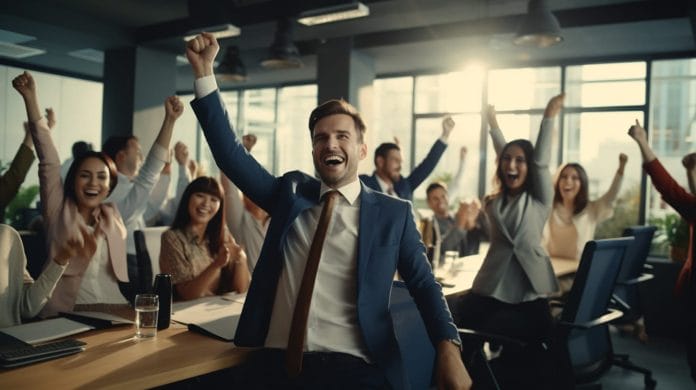 Employees cheering in an office setting.