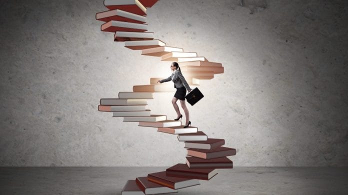A woman walking on book stair representing Career Progression.